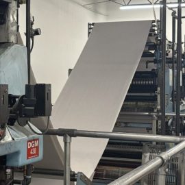 Paper running on a press at The Trust Press